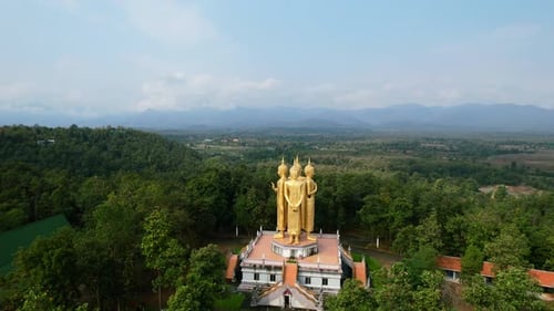 Golden Buddha Statue in a Serene Natural Landscape