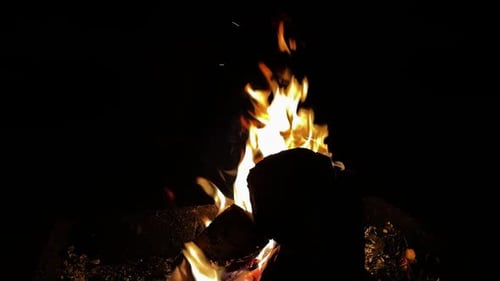 Glowing Campfire at Night with Flickering Flames
