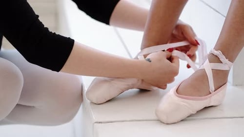 Tying Ribbons on Ballet Shoes