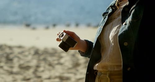 Woman Clicking Photo with Camera at Beach 4k