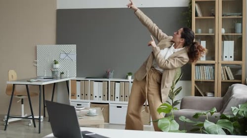 Cheerful Businesswoman Dancing in Office