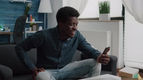 Man Video Chats on Smartphone in Living Room