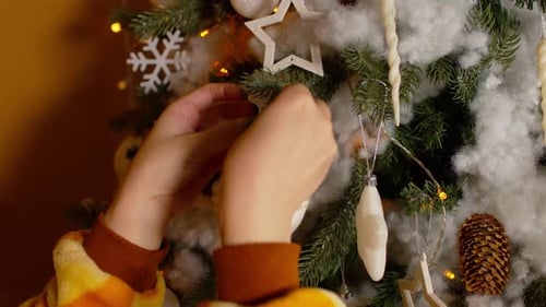 Unrecognizable Person Decorating Christmas Tree