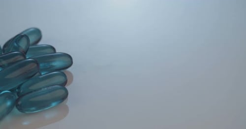 Pile of Blue Gel Capsules on White Background