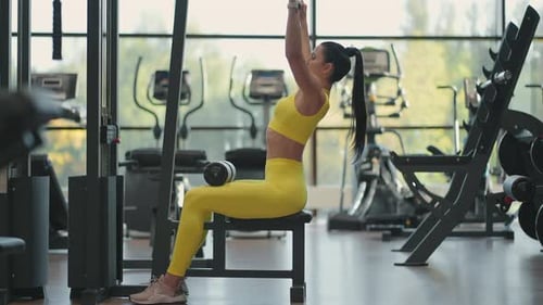 Woman Using Lat Pulldown Machine at Gym