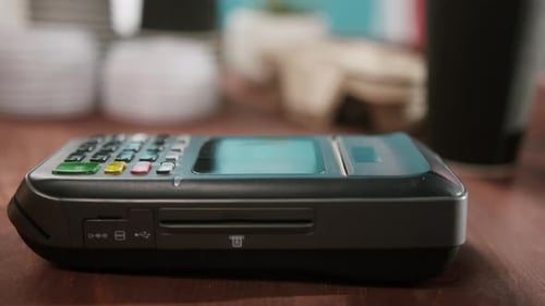 Customer Paying a Merchant with Mobile Phone with NFC Technology Woman in Cafe NFC Payment