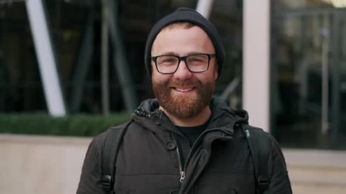 Close Up View of Joyful Bearded Guy in 30s Posing While Looking To Camera, Portrait of Handsome Male