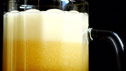Light Beer Being Poured Into Glass Mug