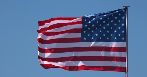American Flag Waving Proudly Against a Blue Sky