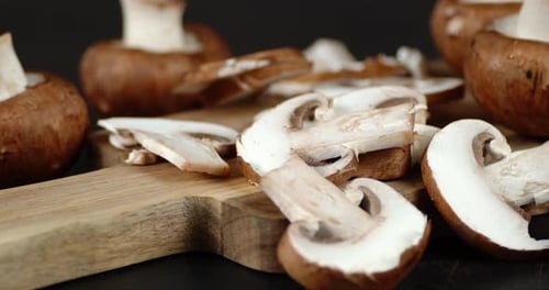 Fresh Brown Mushrooms Sliced on a Wood Board