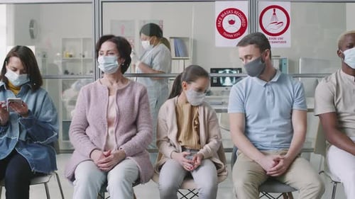 Diverse People In Masks Waiting In Hospital Queue