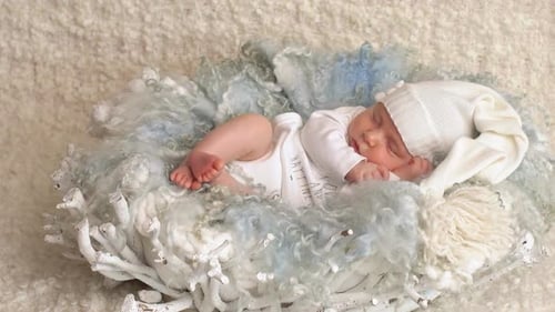 Baby Sleeping Peacefully in White Woolen Basket