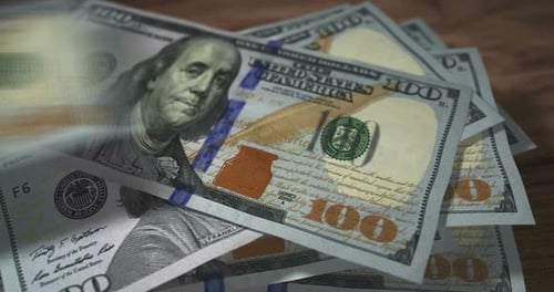 Dollar 100 money banknotes falling on the table