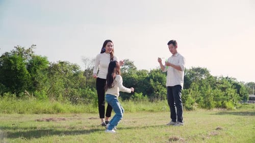 Family Fun Blowing Bubbles in the Meadow