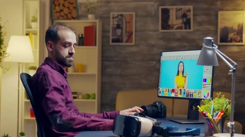 Man Using VR Headset While Photo Editing