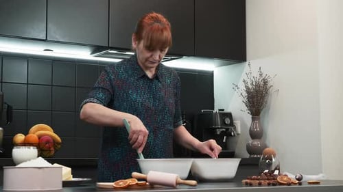 Woman Preparing a Meal in Modern Kitchen
