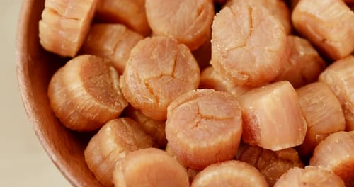 Close Up of Dried Scallops in Wooden Bowl