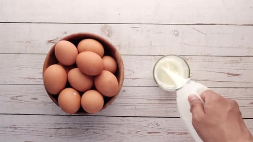 Eggs and Milk on White Wooden Table