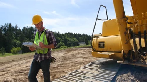 Construction Worker Inspecting Work Site with Clipboard