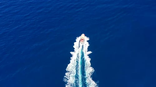 Yacht on the water surface from top view. Turquoise water background from top view. Summer seascape