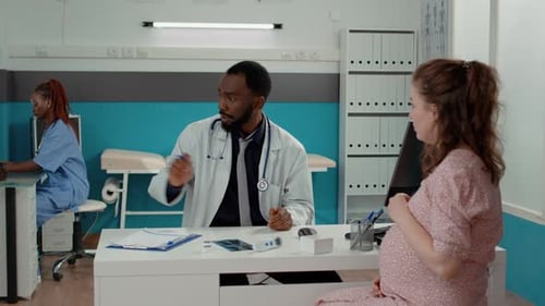 Doctor Explains Medication to Pregnant Patient