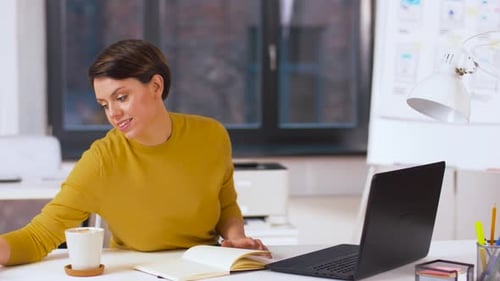 Businesswoman Writing To Notebook at Office 13