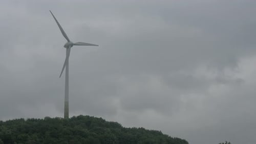 Wind Turbine on Hill With Overcast Sky