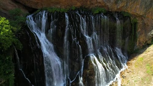 Rocky Waterfall and Travelers