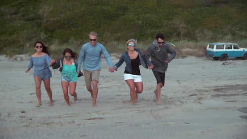 Super slow motion shot of group of friends running at beach, shot with Phantom Flex 4K