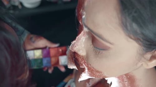 Make up artist make up woman for Halloween and making her zombie mask