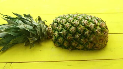 Close Up of Pineapple on Yellow Wooden Surface