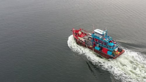 Fisherman out on the sea for a morning catch, aerial drone fly around a traditional fishing boat wit