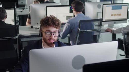 Office Workers Working at Computers in Modern Workplace