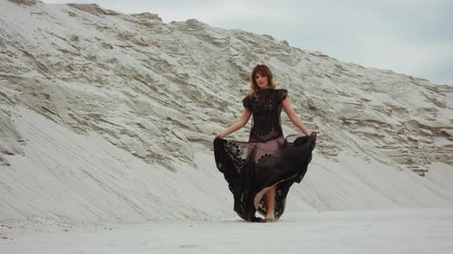 Woman in Dark Dress Posing in Desert