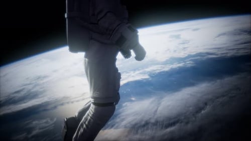 Astronaut Floating in Space Above Planet Earth