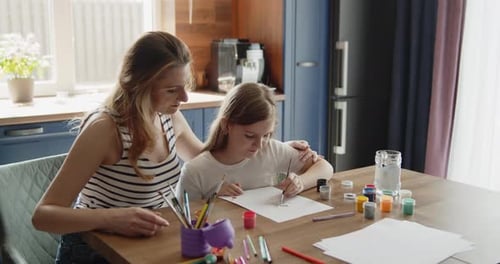 Woman and Child Drawing Together at Home