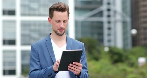 Man Using Tablet Computer in an Urban Setting