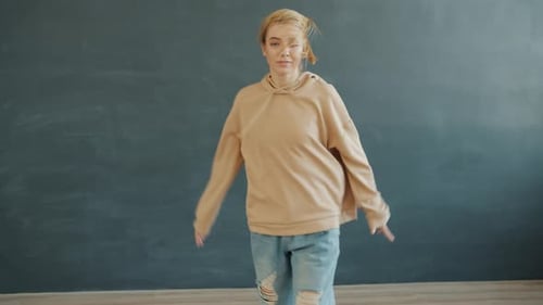 Enthusiastic Woman Dancing in Home Studio