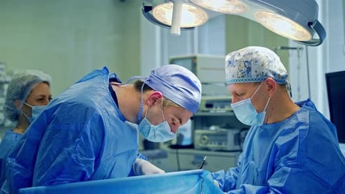Doctors perform an operation using surgical instruments
