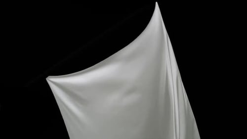 White Cloth Unfurling on a Black Background