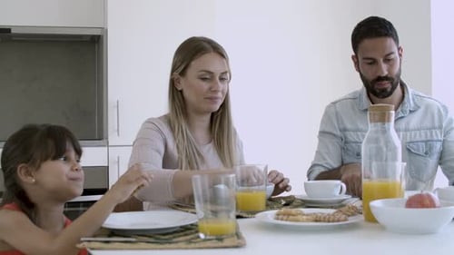 Family Enjoys Breakfast Together at Home