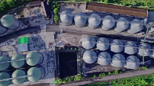 Commercial Grain Or Seed Silos In Sunny Spring Rural Landscape