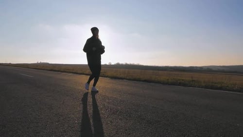 Young Fitness Woman Runner Athlete Running at Road