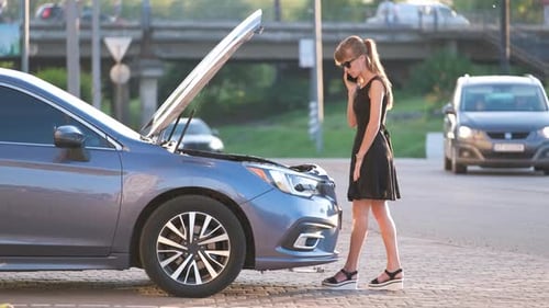 Helpless Woman Standing Near Her Car with Open Bonnet Calling Road Service for Help