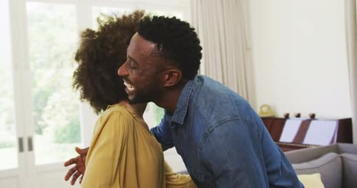 Man and Woman Share Joyful Embrace Indoors