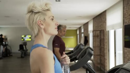 Man and woman exercising in gym