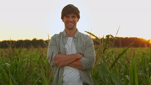 Portrait of a Farmer with His Arms Crossed Standing in a Corn Field Looking at the Camera
