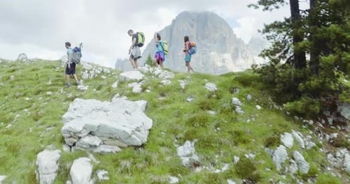 Aerial Flight Above People Hiking Along Trail Path in Sunny Day