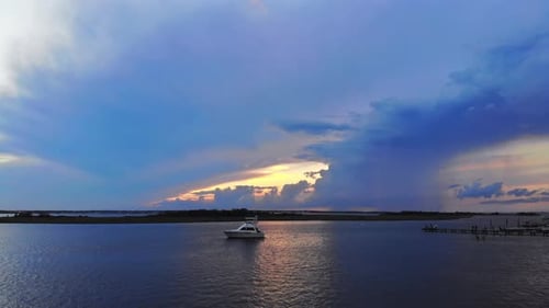 Sunset Over Calm Waters with a Boat
