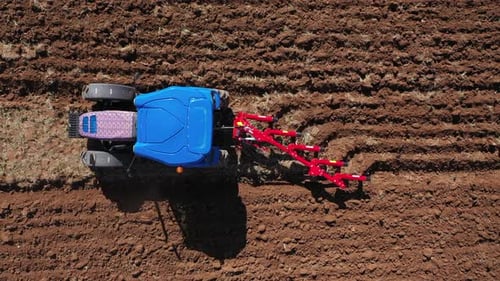 Tractor Plowing Rural Field In Summer Season